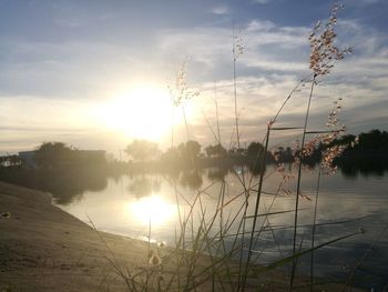 Scenic view of lake against sky during sunset