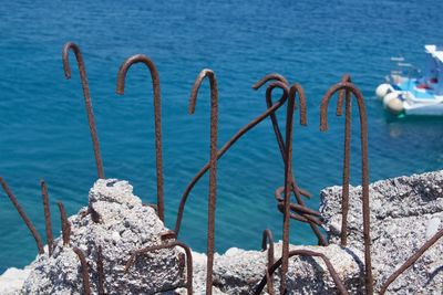 Close-up of metal chain on sea shore during winter