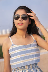 Portrait of beautiful young woman wearing sunglasses