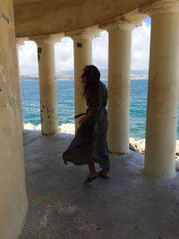 Full length of woman standing at beach