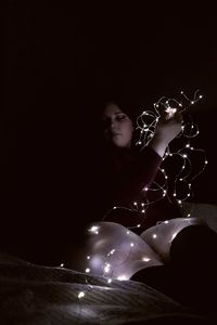 Woman sitting in the dark
