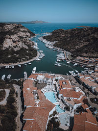 High angle view of townscape by sea against sky