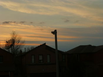 Low angle view of silhouette building against sky at sunset