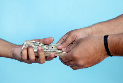 Cropped hand of woman holding model house