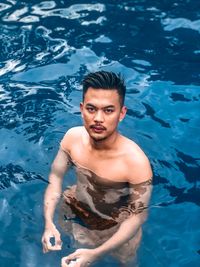 High angle portrait of man in swimming pool