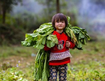 Portrait of girl standing on field