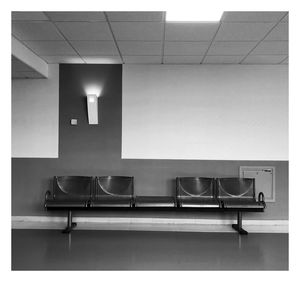 Empty chairs and tables in room