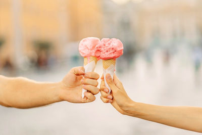 Cropped hand of person holding food