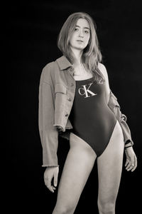 Portrait of a beautiful young woman over black background