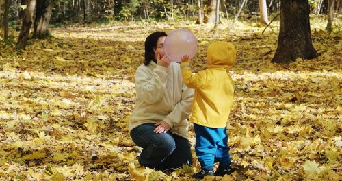 Full length of mother and daughter on dirt road