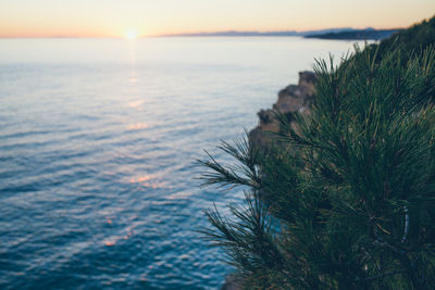 Scenic view of sea against sky at sunset