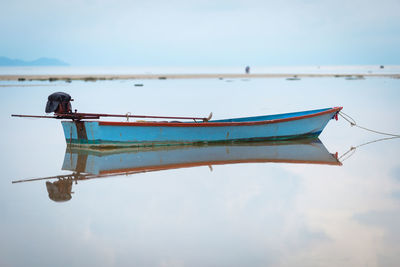 Side view of boat in sea against sky