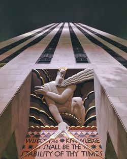 Low angle view of statue against building