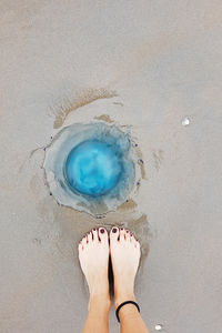 Low section of woman on sand