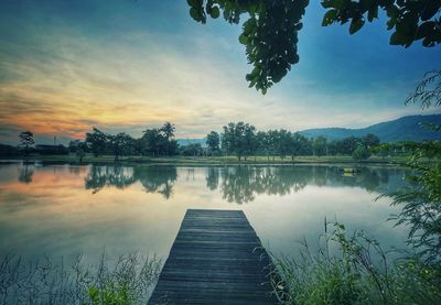 Scenic view of lake against sky during sunset