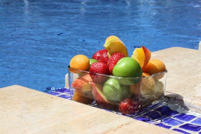 High angle view of fruits on table at swimming pool