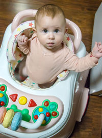 High angle view of cute girl playing with toy on table