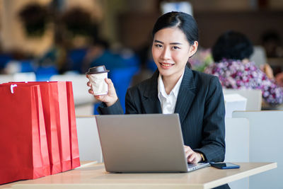 Portrait of young woman using smart phone