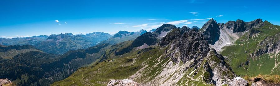 Scenic view of mountains against blue sky