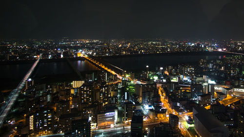 Aerial view of city lit up at night