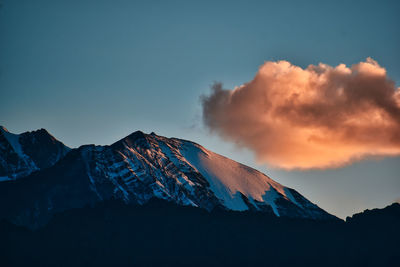 Scenic view of snowcapped mountains against sky during sunset