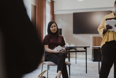 Female colleagues with not pads in meeting at education class