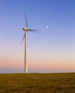 Colorado wind farm located on a wheat field during sunset