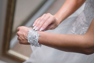Midsection of bride wearing bracelet