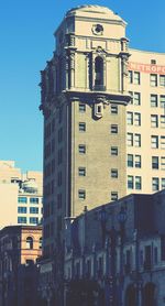 Clock tower in city against sky