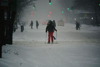 People standing on snow covered landscape