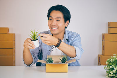 Portrait of young man holding ice cream in box