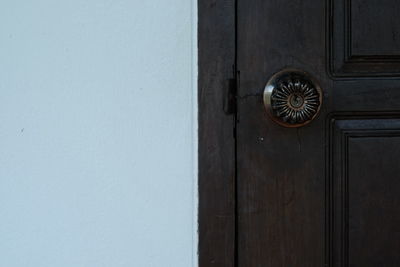 Close-up of keyhole on wooden door