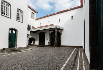 Building by street against sky