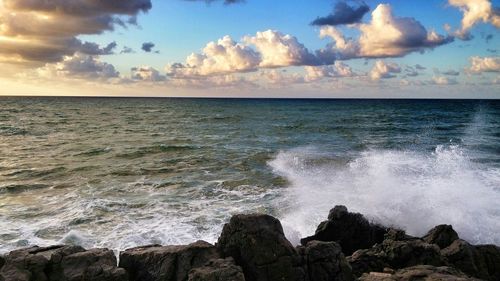 Scenic view of sea against cloudy sky