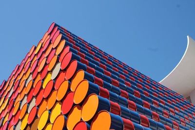 Low angle view of multi colored roof against clear blue sky