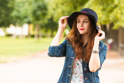 Thoughtful beautiful woman in hat looking away