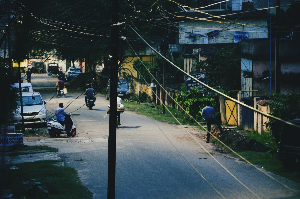 PEOPLE WALKING ON ROAD IN CITY