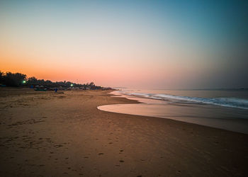 Scenic view of beach against sky during sunset