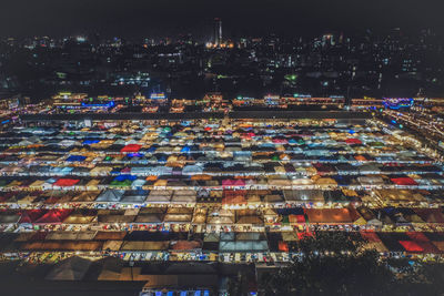 High angle view of illuminated buildings in city at night