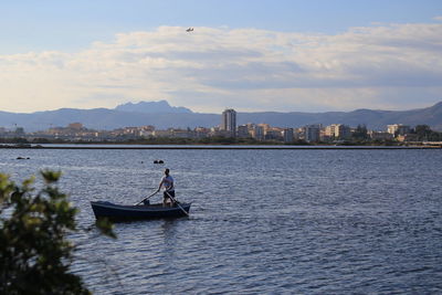 Boat sailing on river against sky