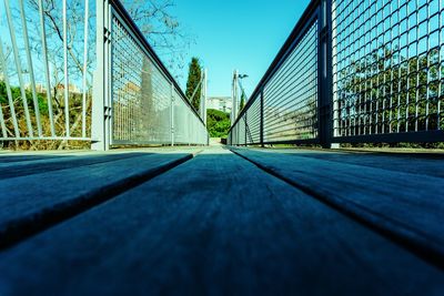 Surface level of bridge against blue sky