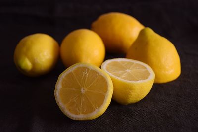 Close-up of oranges on table against black background