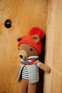 Close-up of stuffed toy hanging against wall