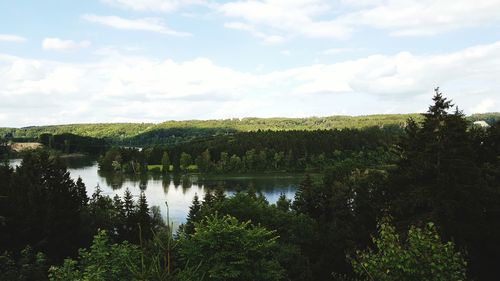 Scenic view of lake against cloudy sky