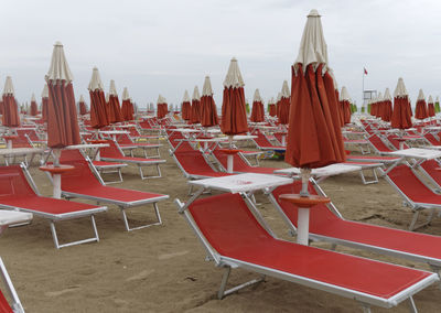 Closed canopy with sun lounger on sand 