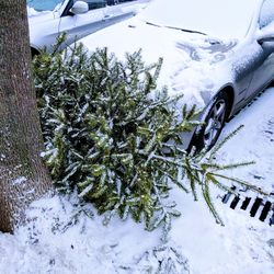 Close-up of frozen car on snow covered field