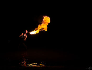 Fire-eater performing at night