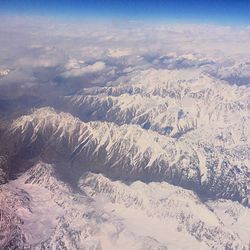 Aerial view of snow covered mountains