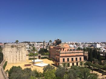 Buildings in town against blue sky