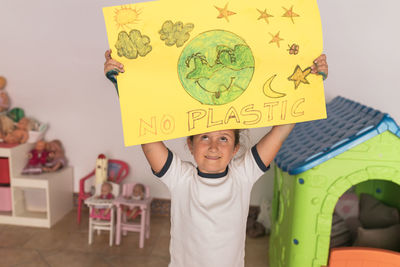 Girl looking at poster while standing at home